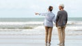 Asian Lifestyle senior couple pointing and hug, stand see beach happy in love romantic and relax time.ÃÂ  Royalty Free Stock Photo